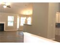 Open-concept living room boasts wood flooring, a fireplace, and plenty of natural light at 84 Jennifer Ln, Covington, GA 30016