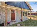 Inviting front porch with brick facade and a welcoming entryway at 1246 Bell Ave, East Point, GA 30344