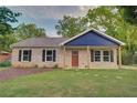 Attractive one-story home featuring a well-maintained front lawn and a welcoming entrance area at 1246 Bell Ave, East Point, GA 30344