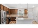 Well-equipped kitchen with wood cabinets, stainless steel appliances, and granite countertops at 1570 Halbrook Pl, Marietta, GA 30008