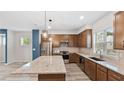 Modern kitchen with stainless steel appliances, a large granite island, and sleek cabinetry, offering a lot of counterspace at 1570 Halbrook Pl, Marietta, GA 30008
