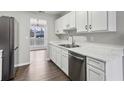 Clean kitchen featuring stainless steel appliances and bright, white cabinetry at 4975 Rockstone Way, Acworth, GA 30101