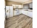 Well-lit kitchen features white cabinets, updated appliances and modern wood-look flooring at 51 Highoak Ne Dr # 12, Marietta, GA 30066