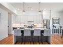 Modern kitchen features a large island with bar seating and pendant lighting, stainless steel appliances and sleek cabinetry at 1099 Hawthorne Ne St, Atlanta, GA 30307