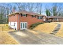 A single Gathering home with a large driveway and an expansive lawn and minimal landscaping at 3406 Woodview Se Dr, Smyrna, GA 30082