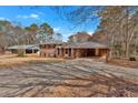 Lovely brick home featuring a metal roof, covered carport, and ample parking space at 4480 Highway 5, Douglasville, GA 30135