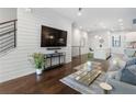 Bright living room with hardwood floors, modern decor, and shiplap accent wall at 105 City View Ne Ct, Atlanta, GA 30308