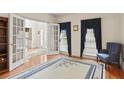 Cozy living room with hardwood floors, French doors, large windows, and an ornate area rug at 1274 Creek Laurel Dr, Lawrenceville, GA 30043