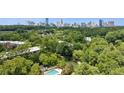 Stunning aerial view of the property showcasing lush greenery and the city skyline in the background at 24308 Plantation Ne Dr, Atlanta, GA 30324