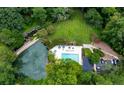 An aerial view showcasing the pool and outdoor amenities surrounded by lush landscaping and mature trees at 24308 Plantation Ne Dr, Atlanta, GA 30324