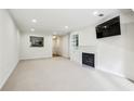 Bright and airy living room featuring fresh white walls, neutral carpet, a fireplace, and recessed lighting at 24308 Plantation Ne Dr, Atlanta, GA 30324