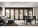 Elegant living room featuring a grand piano, plush seating, and large windows for natural light at 437 Hollydale Nw Ct, Atlanta, GA 30342