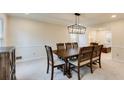 Formal dining room with a dark wood table, chair rail detail, and modern light fixture at 5322 Seaton Dr, Dunwoody, GA 30338