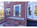 A welcoming front entrance with a dark door, sidelights, and brick steps at 2001 Towne Lake W Hls, Woodstock, GA 30189