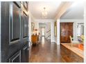 Long Foyer with dark wood flooring and a view into other rooms at 3448 Paces Ferry Cir, Smyrna, GA 30080