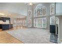 Bright living room featuring soaring ceilings, large windows, and elegant fireplace at 3502 Crown Peak Ct, Suwanee, GA 30024