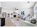 Spacious living room with fireplace, ceiling fan, and hardwood floors at 900 Melrose Park Pl, Lawrenceville, GA 30044