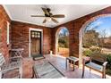 Inviting brick front porch featuring a ceiling fan and a comfortable seating area at 1272 Oakdale Ne Rd, Atlanta, GA 30307