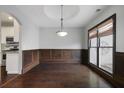 Cozy dining room with hardwood floors, wainscoting, and a modern light fixture at 1278 Crown Ter, Marietta, GA 30062