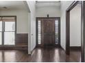 Elegant front entryway featuring a wooden door with glass panels and dark wood flooring at 1278 Crown Ter, Marietta, GA 30062