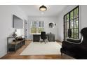 Well-lit home office with a large window, modern desk, and comfortable seating, ideal for productivity at 239 E Wesley Ne Rd, Atlanta, GA 30305