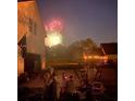 People gathered on lawn watching fireworks, beside a house with basketball court at 2982 N Main Nw St, Kennesaw, GA 30144