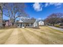 Charming home with a front porch, long driveway, spacious lawn and a detached garage at 2982 N Main Nw St, Kennesaw, GA 30144