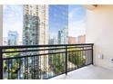 Balcony view showcases towering high-rise buildings and lush greenery, providing a serene outdoor living space at 3445 Stratford Ne Rd # 1605, Atlanta, GA 30326