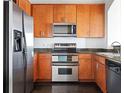 Updated kitchen featuring stainless steel appliances, wood cabinets, and granite countertops at 3445 Stratford Ne Rd # 1605, Atlanta, GA 30326