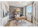 Well-lit home office with french doors, stylish shelving, and a large window at 8518 Polston Place Lot 131, Douglasville, GA 30134