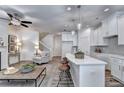 Open-concept living space with a modern kitchen, fireplace, and comfortable seating area at 2702 Ne Almand Lane, Conyers, GA 30013