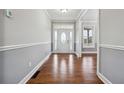 Bright foyer with hardwood floors and a decorative front door at 2984 Berry Rd, Loganville, GA 30052