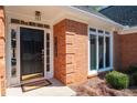 Close-up of elegant front entrance featuring black door and bright sidelights at 330 Todwick Dr, Roswell, GA 30075