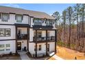 Modern two-story townhome featuring black accents and a cozy front porch at 800 Mackay Crk, Woodstock, GA 30188