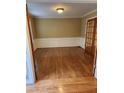 Dining room featuring rich hardwood flooring, modern wall paneling, and a transom door at 9936 Point Vw, Jonesboro, GA 30238