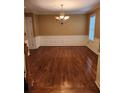 Dining room with chair rail molding, hardwood floors, and a chandelier at 9936 Point Vw, Jonesboro, GA 30238