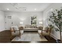 Bright living room featuring hardwood floors, neutral furniture, and a contemporary ceiling fan at 1272 Hardee Ne St, Atlanta, GA 30307
