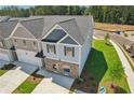 Aerial view of two-story home with gray siding, brick accents, well-manicured lawn, and attached two-car garage at 161 Stanchion Dr, Union City, GA 30291