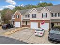 Shot of the exterior elevation of townhomes featuring attached garages and private driveways at 28 Eagle Glen Ne Dr, Cartersville, GA 30121