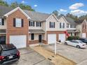 Exterior view of townhomes showing garages, driveways, and a Georgia Bulldog banner at 28 Eagle Glen Ne Dr, Cartersville, GA 30121