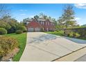 Beautiful brick home featuring a spacious driveway and a lush green lawn at 56 Ruth Way, Douglasville, GA 30134