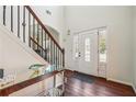 Elegant foyer featuring hardwood floors, staircase with iron railing, and a stylish console table at 56 Ruth Way, Douglasville, GA 30134