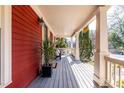 Spacious front porch with gray painted wood and supporting white columns at 944 Cherokee Se Ave, Atlanta, GA 30315