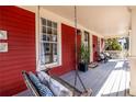 Cozy front porch with a swing, seating, and red siding at 944 Cherokee Se Ave, Atlanta, GA 30315