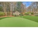 Private backyard featuring a putting green and lush landscaping at 15 Northwood Ne Ave, Atlanta, GA 30309