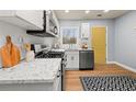 Well-lit kitchen featuring stone countertops and stainless steel appliances at 1707 Terry Mill Se Rd, Atlanta, GA 30316