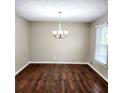 Cozy dining room with hardwood floors, neutral paint, and a classic chandelier at 2724 Hickory Smoke Ct, Snellville, GA 30078