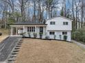Charming two-story home with white exterior, covered porch, and well-maintained landscaping at 847 Magna Carta Nw Dr, Atlanta, GA 30318