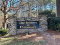 Stone entrance sign for The Reserve of Dunwoody shows established community appeal at 9400 Roberts Dr # 6C, Atlanta, GA 30350