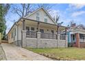 Charming renovated home featuring a covered front porch and stone foundation at 966 Ashby Grove Sw St, Atlanta, GA 30314